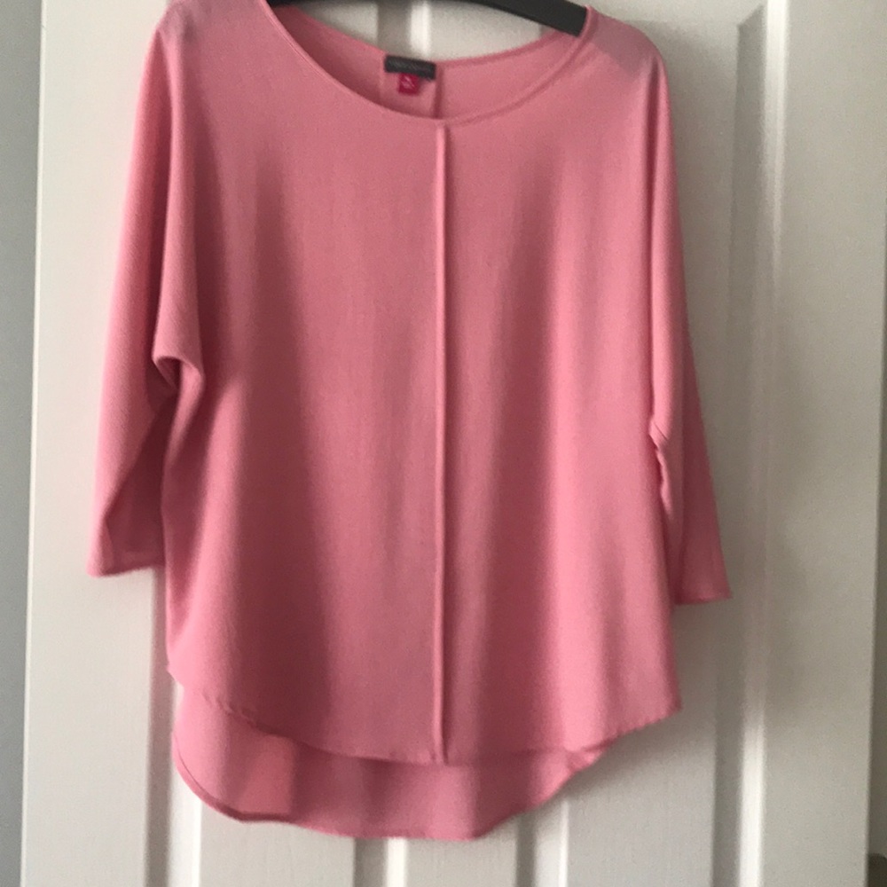 Carnation pink blouse with dolman sleeves.